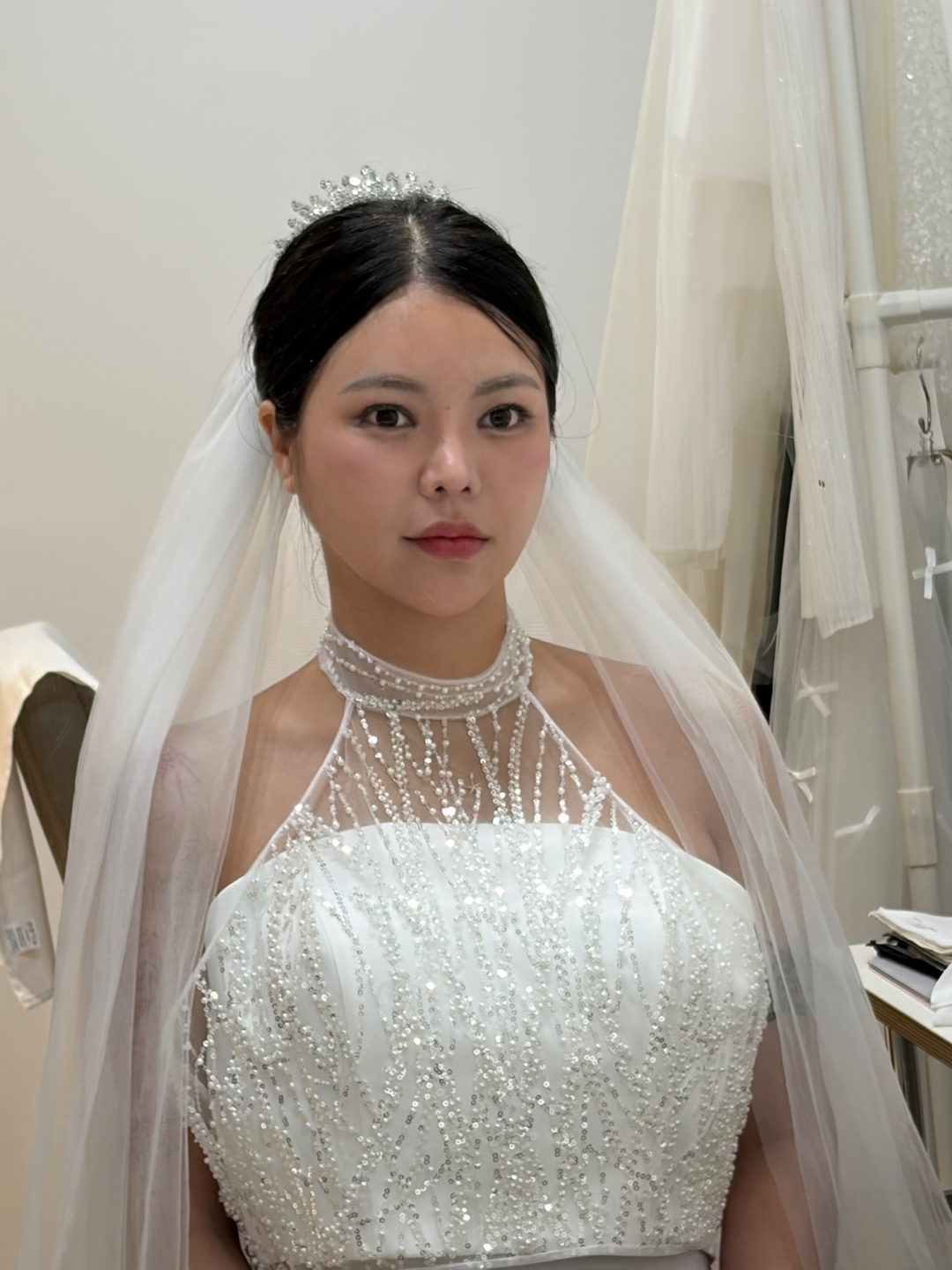 A bride in veil and beaded gown after a wedding styling consultation