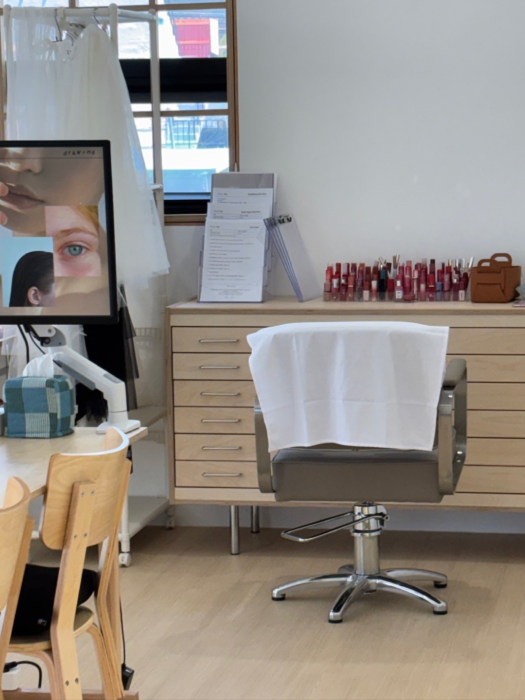 Result sheets and lip colour range beside the consultation chair