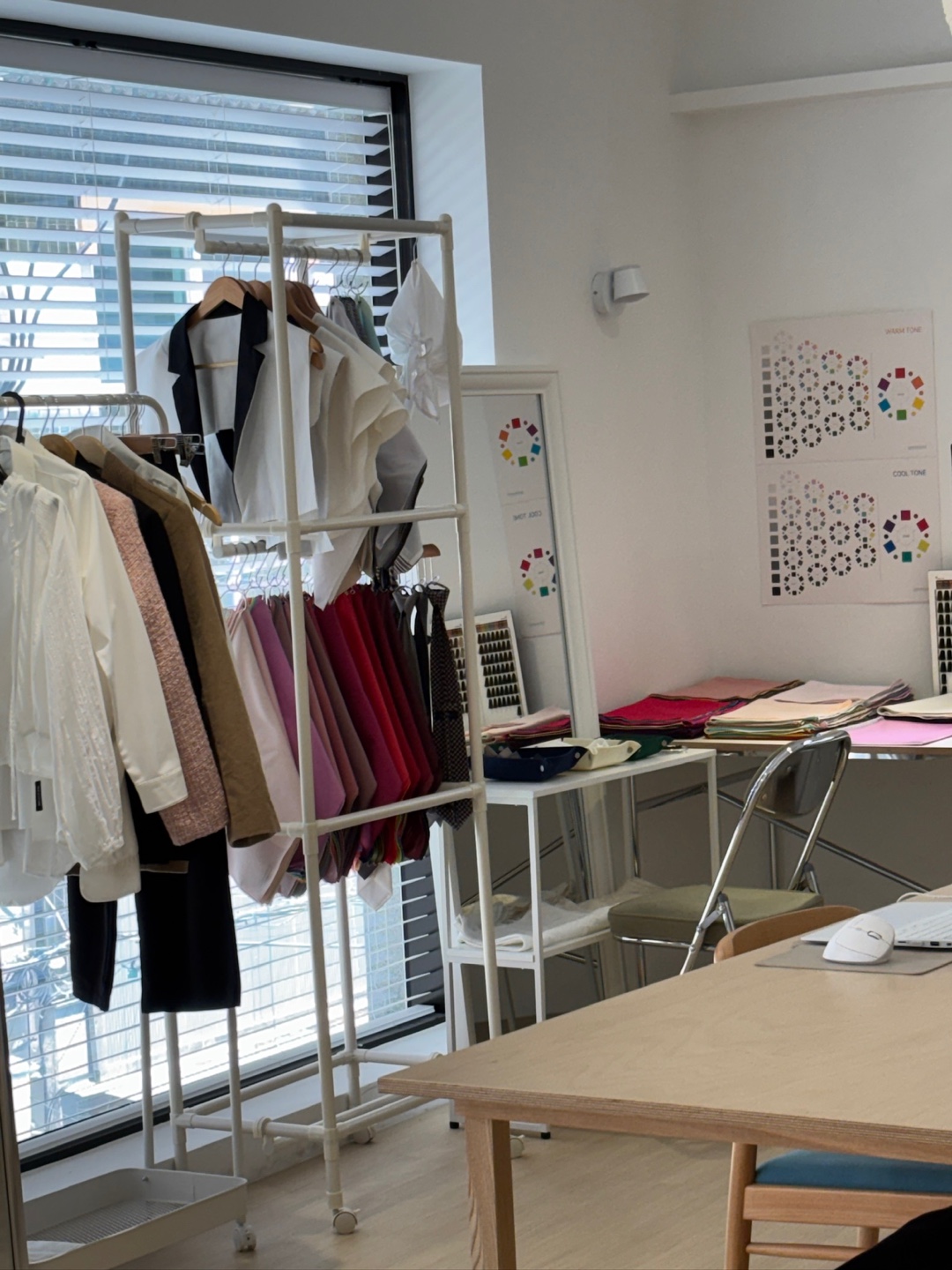 Garment rack and colour charts by the studio window